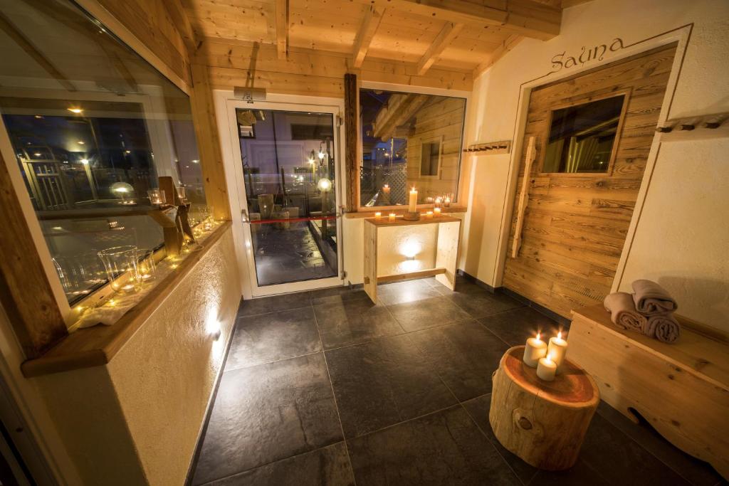 a room with candles on the floor of a building at Hotel Bellaria in Predazzo