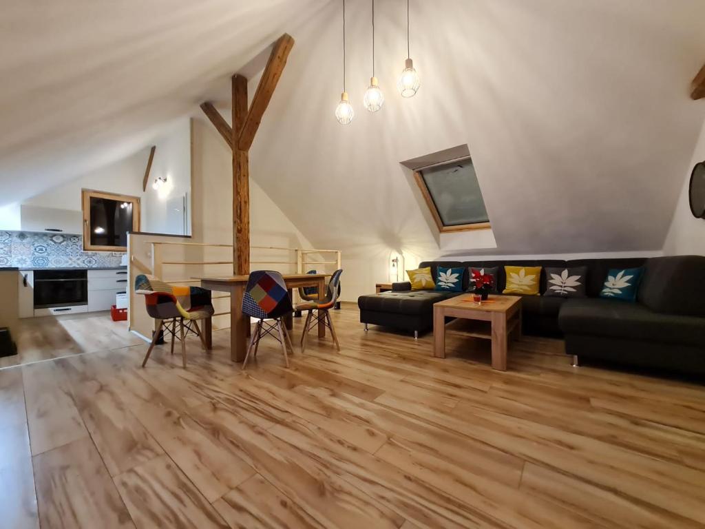 a living room with a couch and a table at Apartmán Konírna in Harrachov