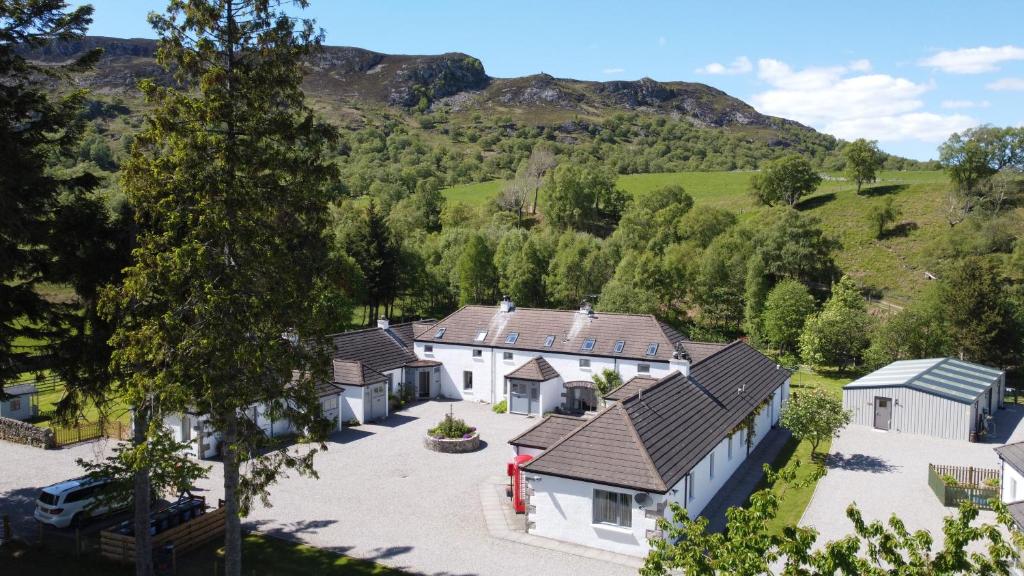 an aerial view of a house in the mountains at Highland Holiday Cottages in Newtonmore