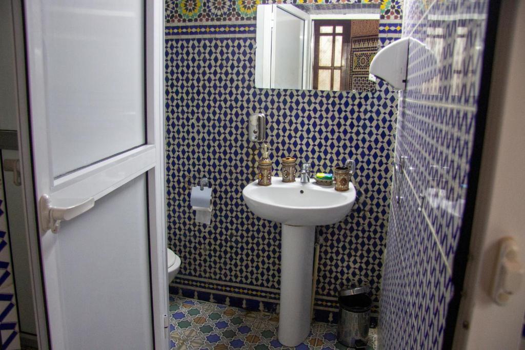 a bathroom with a sink and a mirror at Riad Baba in Fez