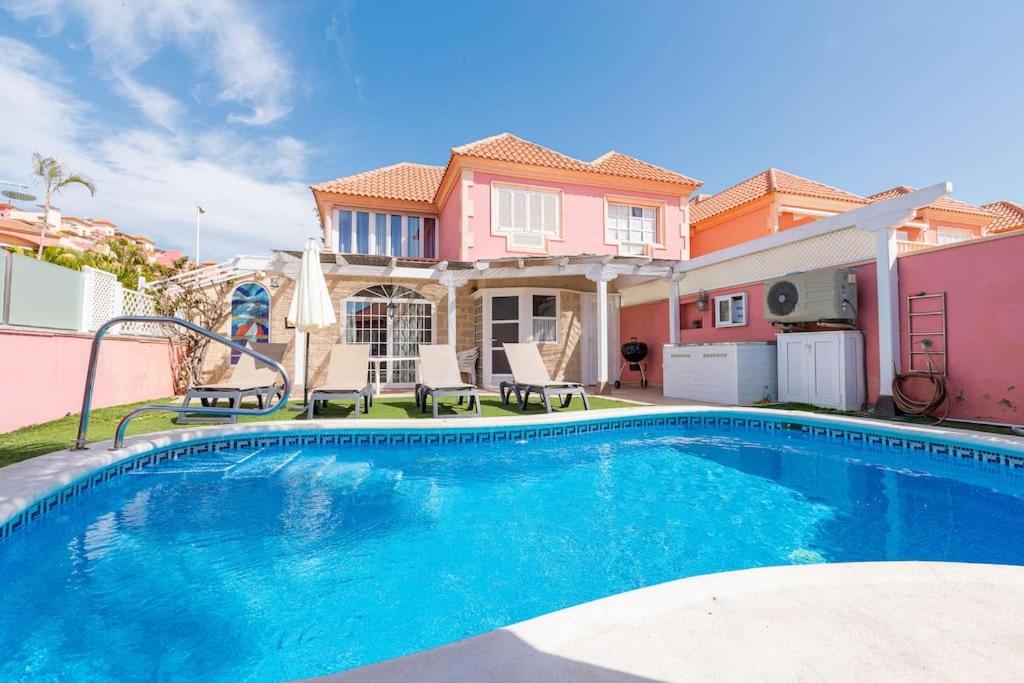 a swimming pool in front of a house at Nice 3 Bedroom Villa in El Duque in Adeje