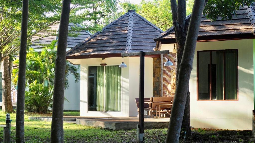 a cottage in the middle of a forest at Avare Seaside House Krabi in Ao Nam Mao