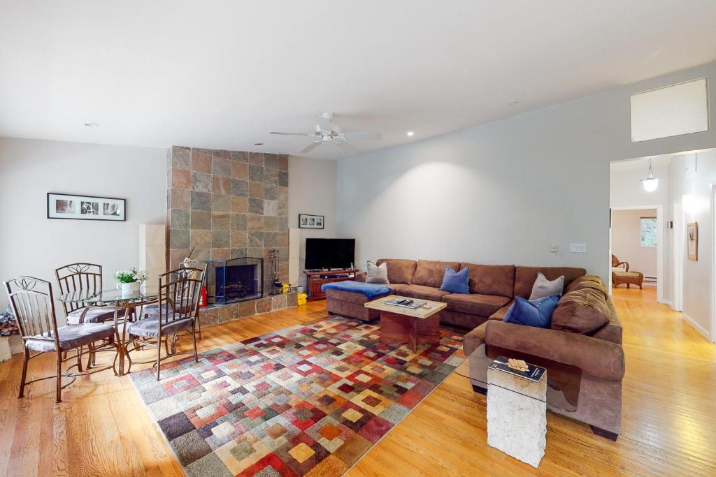 a living room with a couch and a fireplace at River Paradise in Guerneville