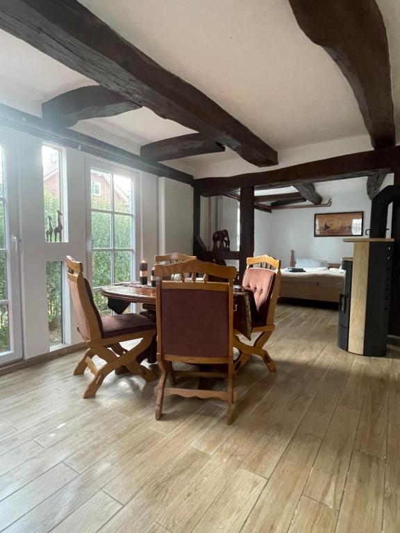 a dining room with a table and chairs and a bed at Hexenhüsli Waake 