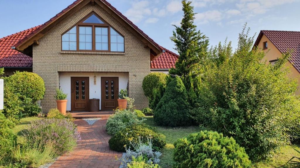 a house with a brick walkway leading to the front door at Haus Krone in Teterow