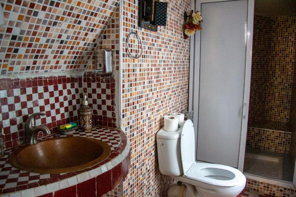 a bathroom with a sink and a toilet in it at Riad Baba in Fez