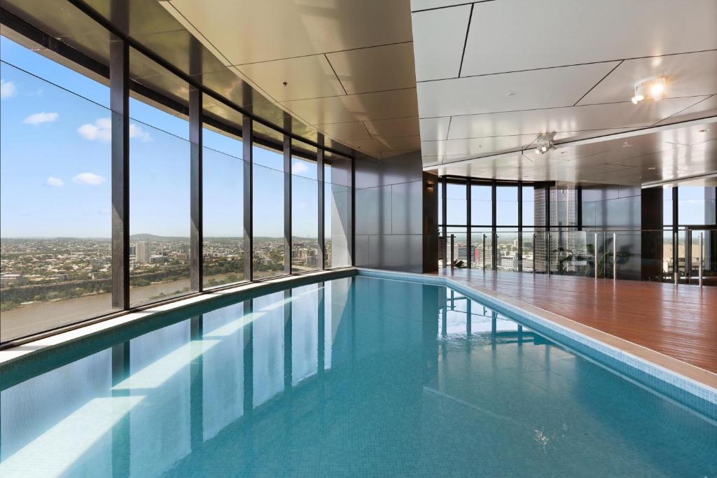 a swimming pool in a building with a view at CBD Cozy 2Beds Apt at Brisbane Tallest building With Free Parking in Brisbane