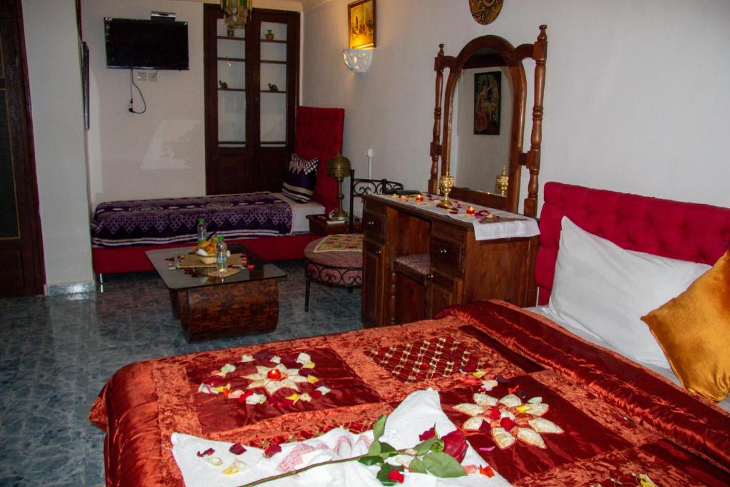 a hotel room with a bed and a room with at Riad Baba in Fez