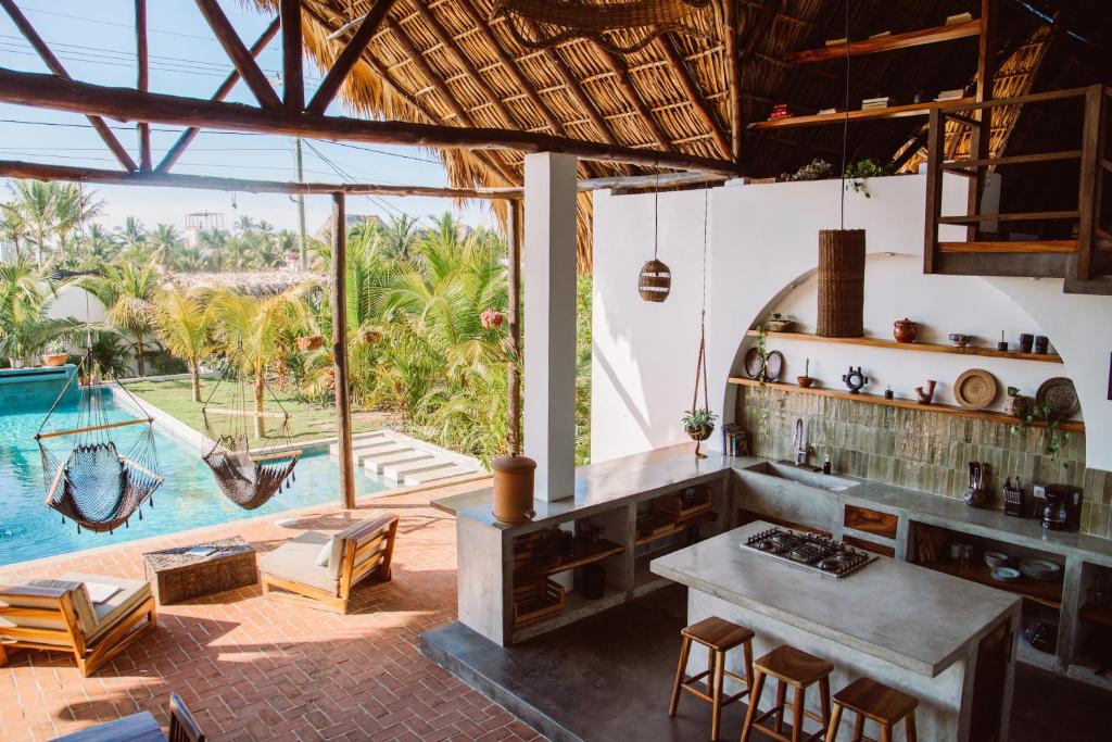 a kitchen with a table and a swimming pool at Casa Zala in El Paredón Buena Vista