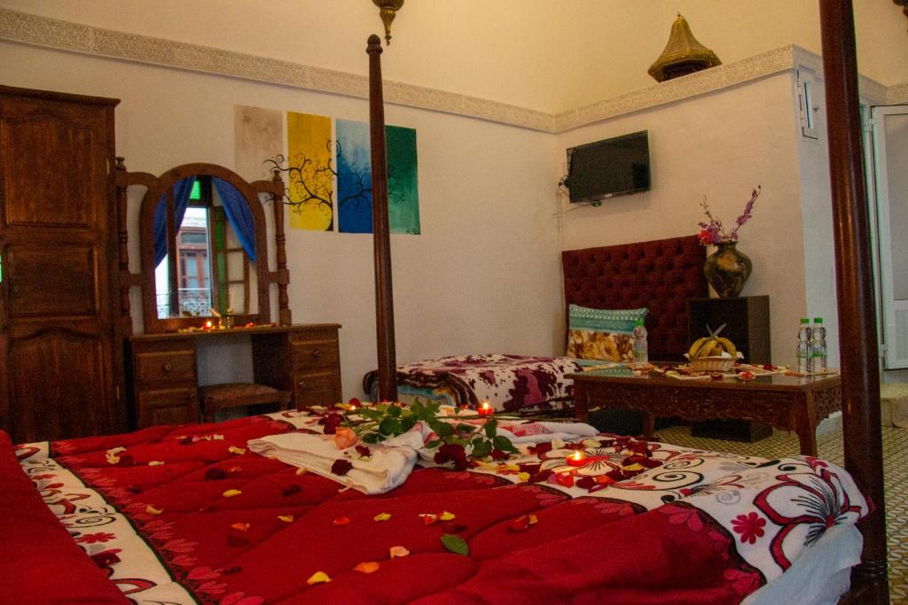 a bedroom with a bed with christmas decorations on it at Riad Baba in Fez