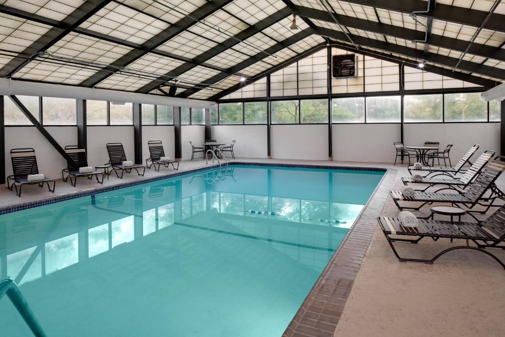 a large swimming pool with chairs and tables at Hyatt Place Princeton in Princeton