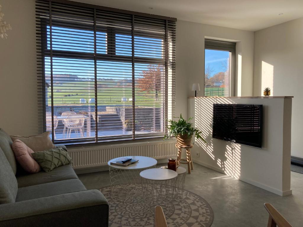 a living room with a couch and a table at Vakantiewoningen Liefst in Epen in Epen