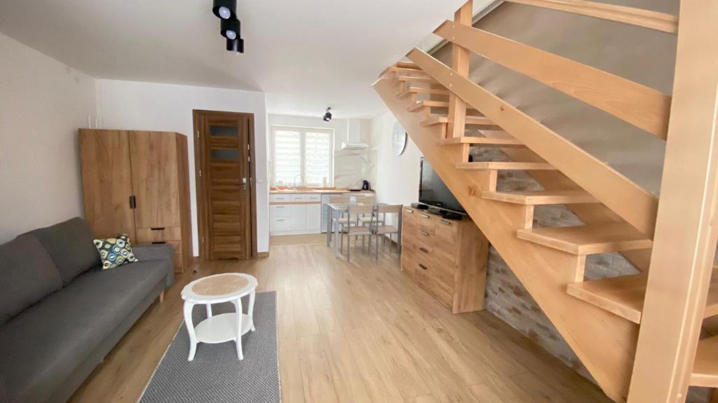 salon ze schodami i kuchnią w obiekcie Apartamenty Młynne w Muszynie