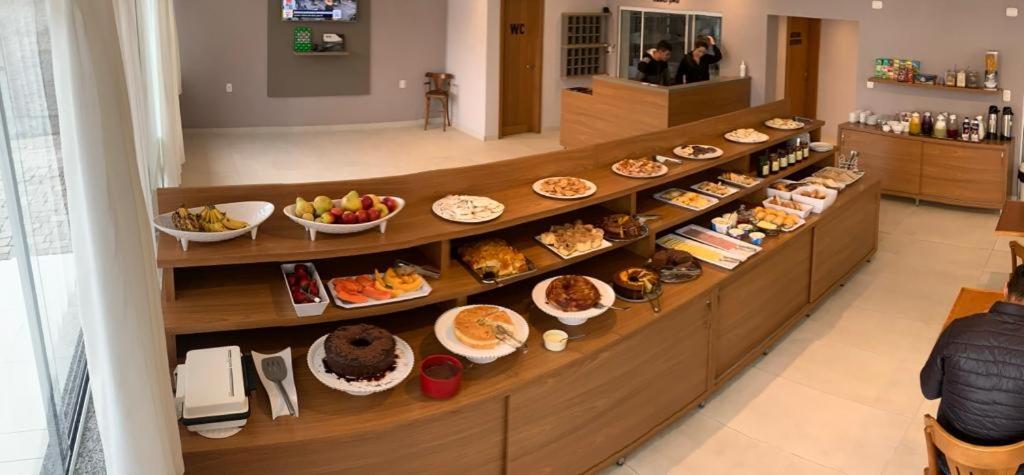 ein Buffet mit vielen verschiedenen Arten von Speisen vorhanden in der Unterkunft Hotel Villa Inácia in Vacaria
