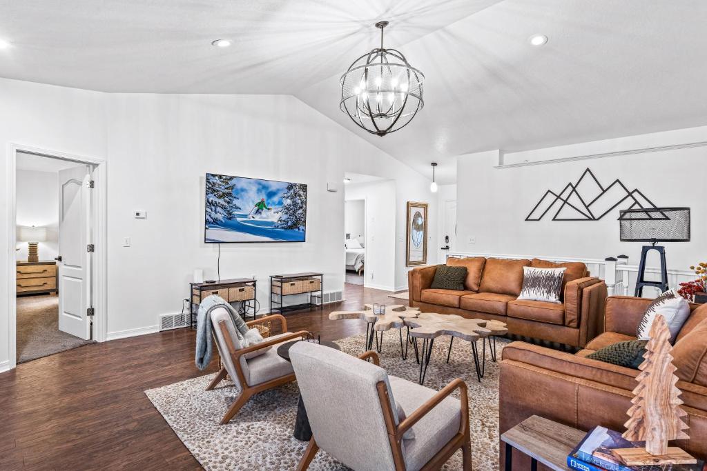 a living room with a couch and a table at Quiet Comfortable Cliffside Estate near USU in Logan