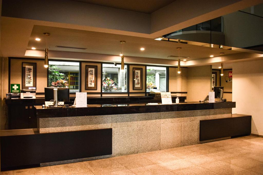 a hotel lobby with a bar with a counter at Ramada by Wyndham Mexico City Santa Fe in Mexico City