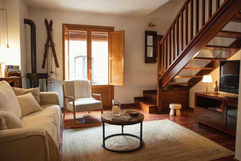 a living room with a couch and a table at El Piolet de Camprodon in Camprodon