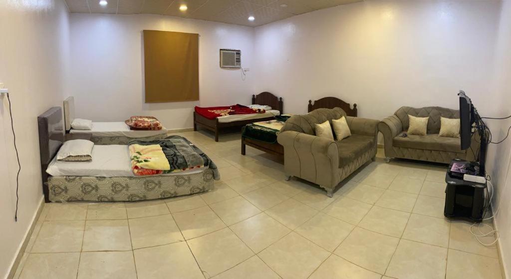 a living room with a couch and a couch at Almazham holiday house in Al-ʿUla