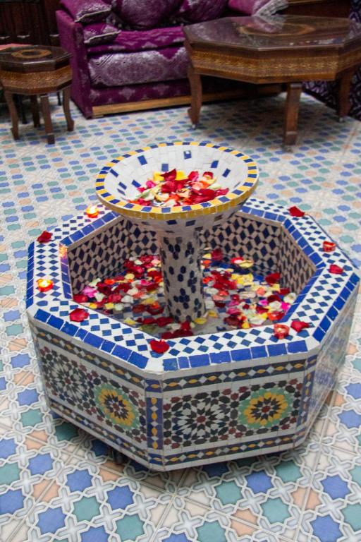 a table sitting on top of a table in a room at Riad Baba in Fez