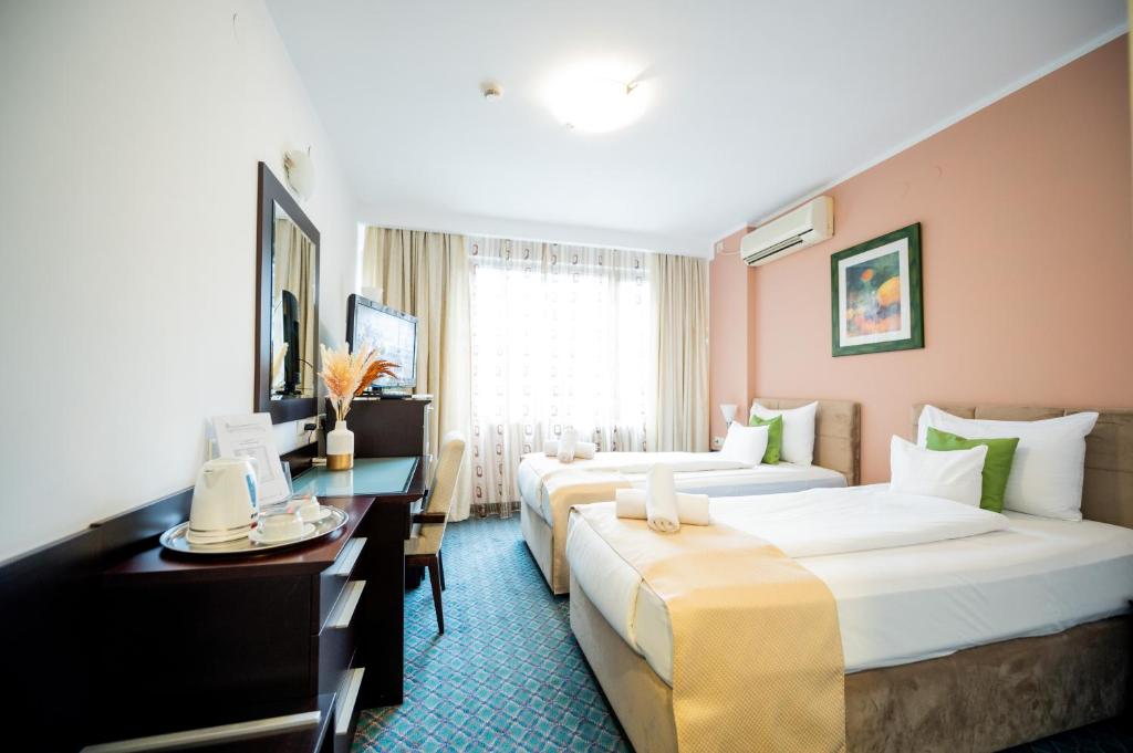 Postel nebo postele na pokoji v ubytování Hotel Sumadija