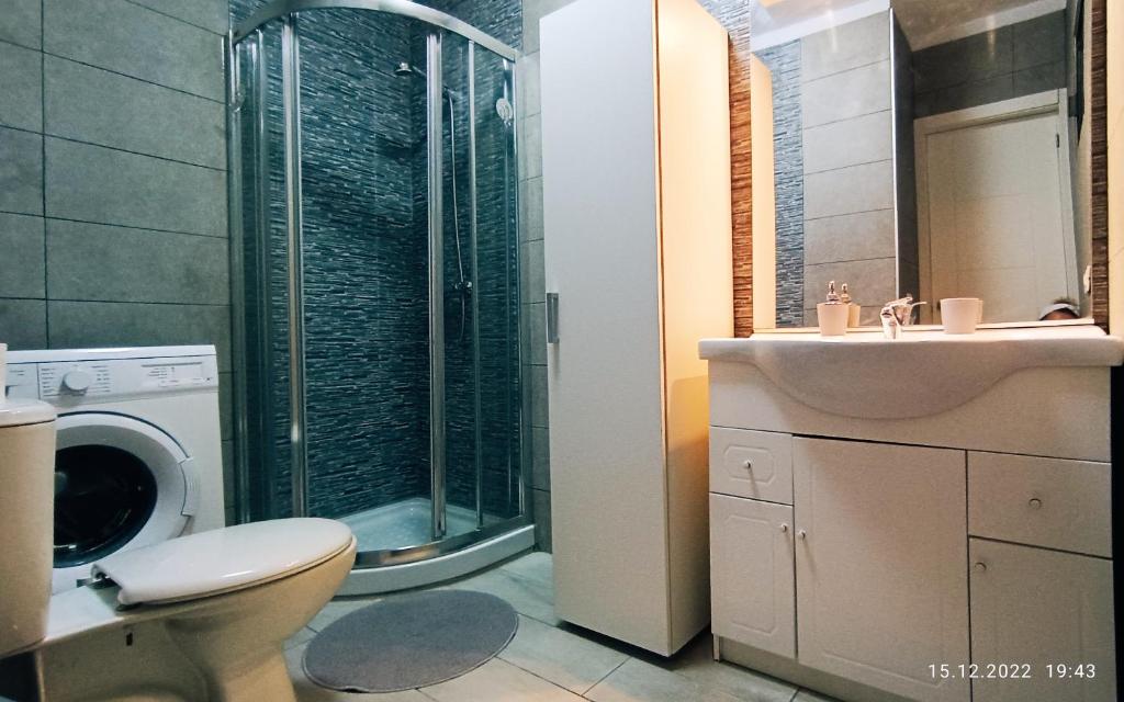 a bathroom with a toilet and a sink and a washing machine at MNG-APART Studio D-14 Mareverde Costa Adeje in Adeje