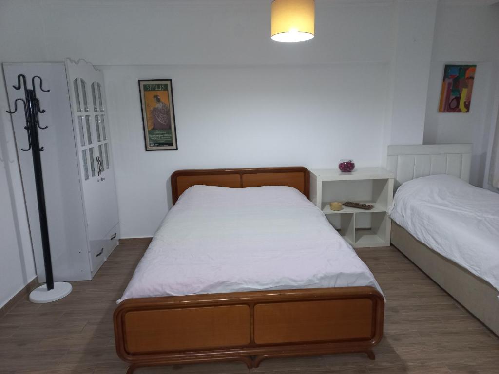 a small bedroom with two beds and a lamp at Silent Corner 1 in Istanbul
