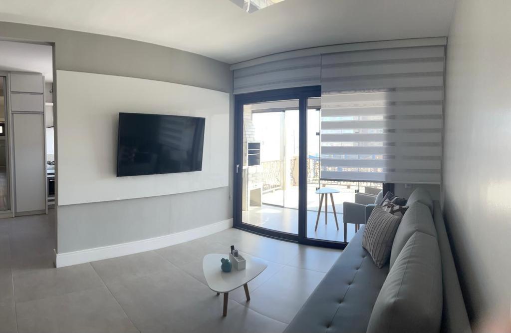 Μια τηλεόραση ή/και κέντρο ψυχαγωγίας στο Apartamento Beira Mar Arroio do Silva - 3 quartos - nº42