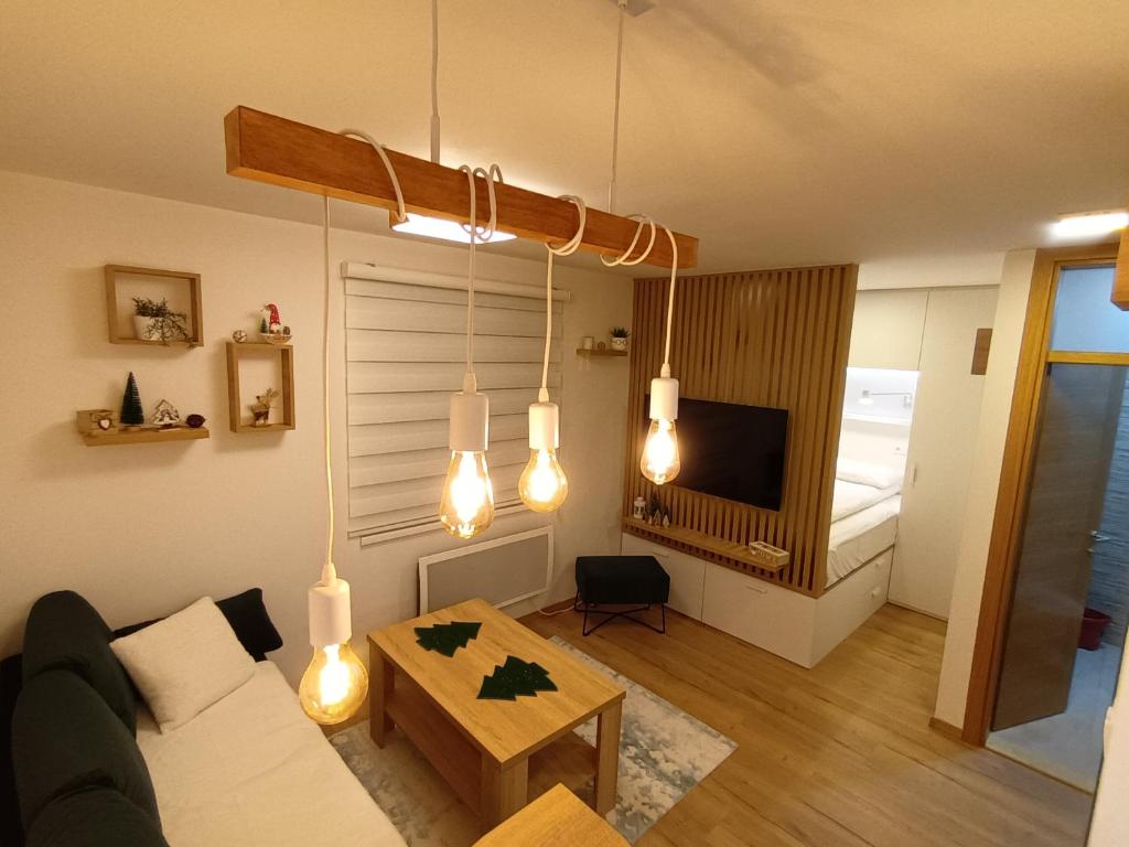 a living room with a couch and a table at Acero Verde Jahorina in Jahorina