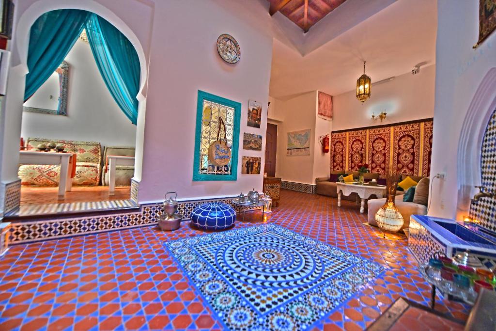 a living room with a blue and white tile floor at Riad Darna in Tétouan