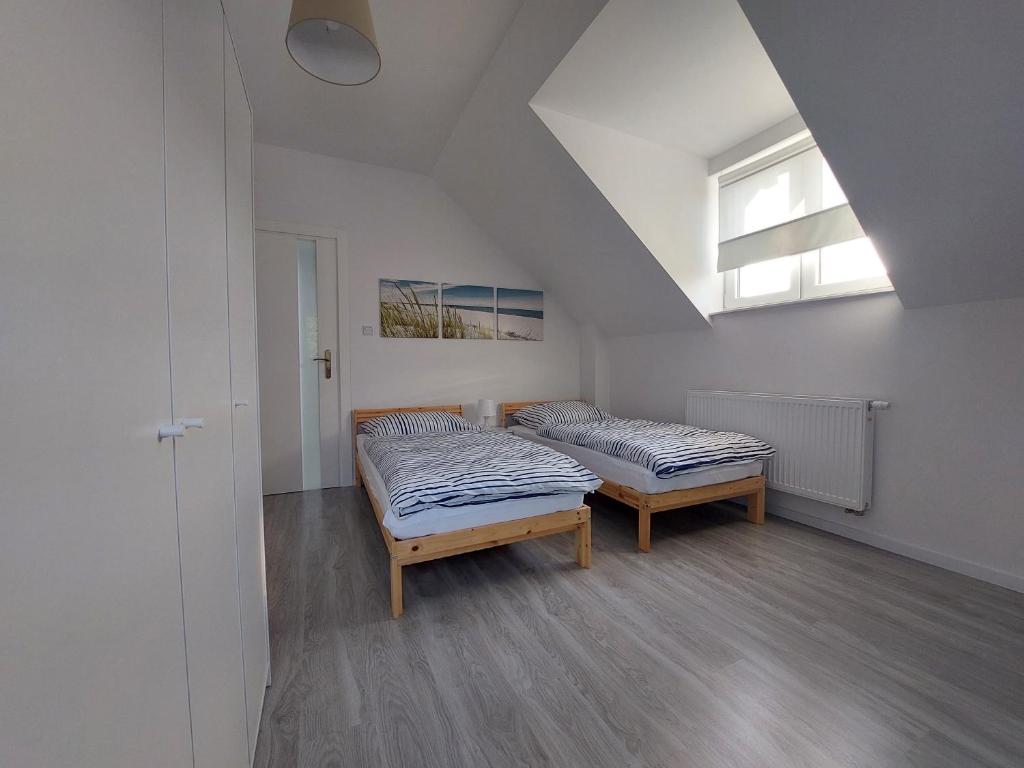 a room with two beds and a window at Holiday Home Mierki 2 in Olsztynek