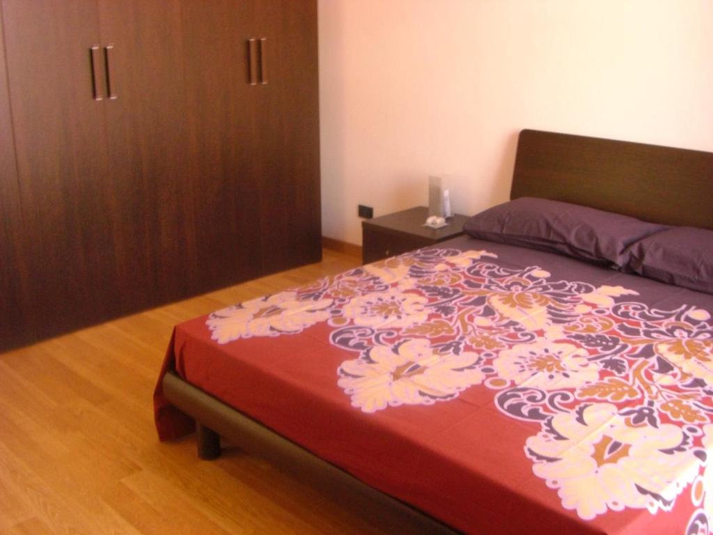 a bedroom with a bed with a red and white blanket at Venice 4 You in Mestre