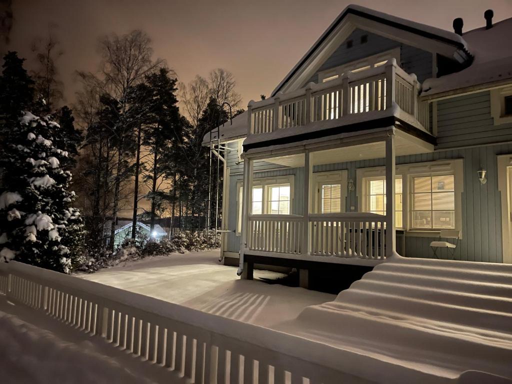 a house with snow on the steps of it at Pan Golf & Spa Villas in Imatra
