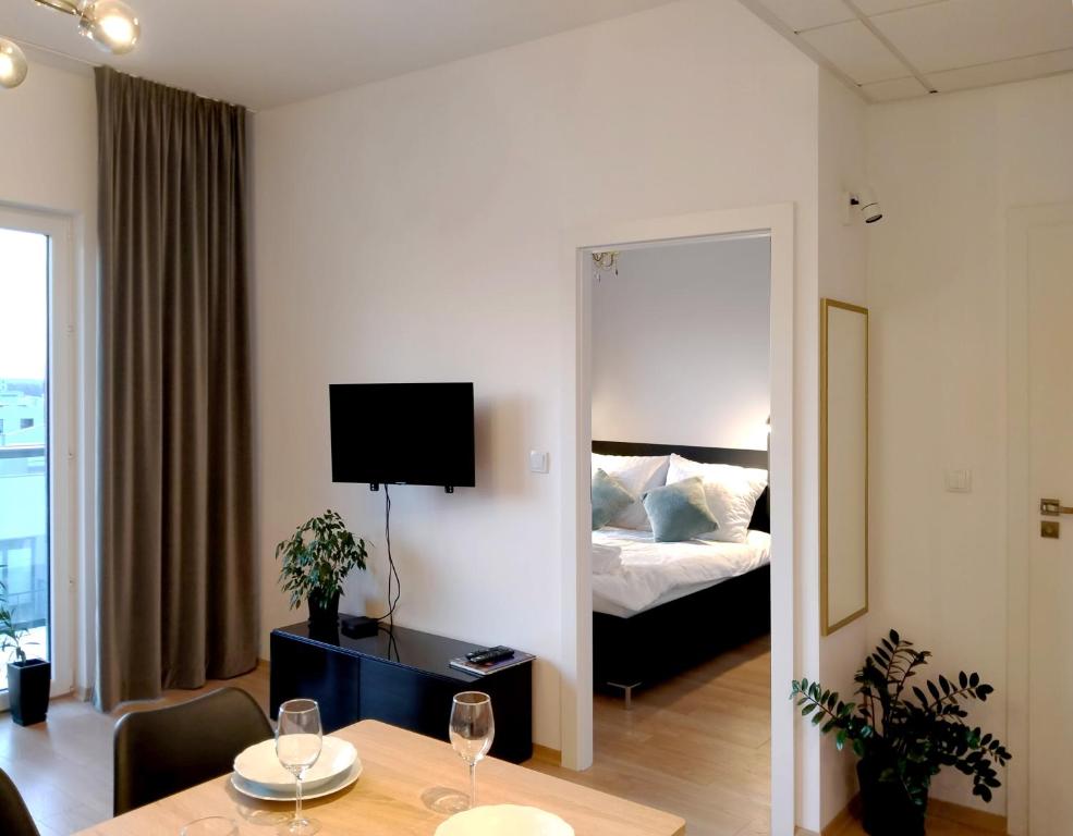 a hotel room with a bed and a table and a mirror at Apartament 9, z oddzielną sypialnią! in Warsaw