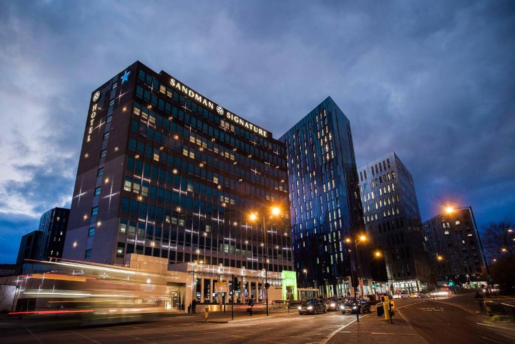 two tall buildings in a city at night at Sandman Signature Newcastle Hotel in Newcastle upon Tyne