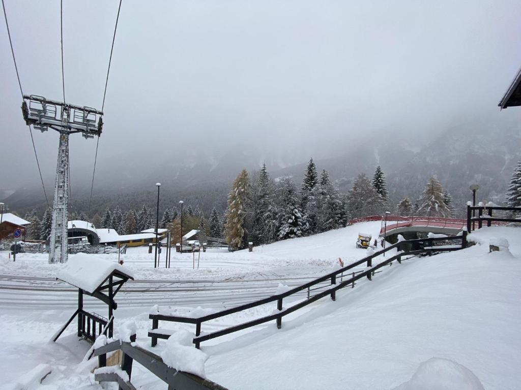 a snow covered ski slope with a ski lift at Casa vacanza Folgarida in Folgarida