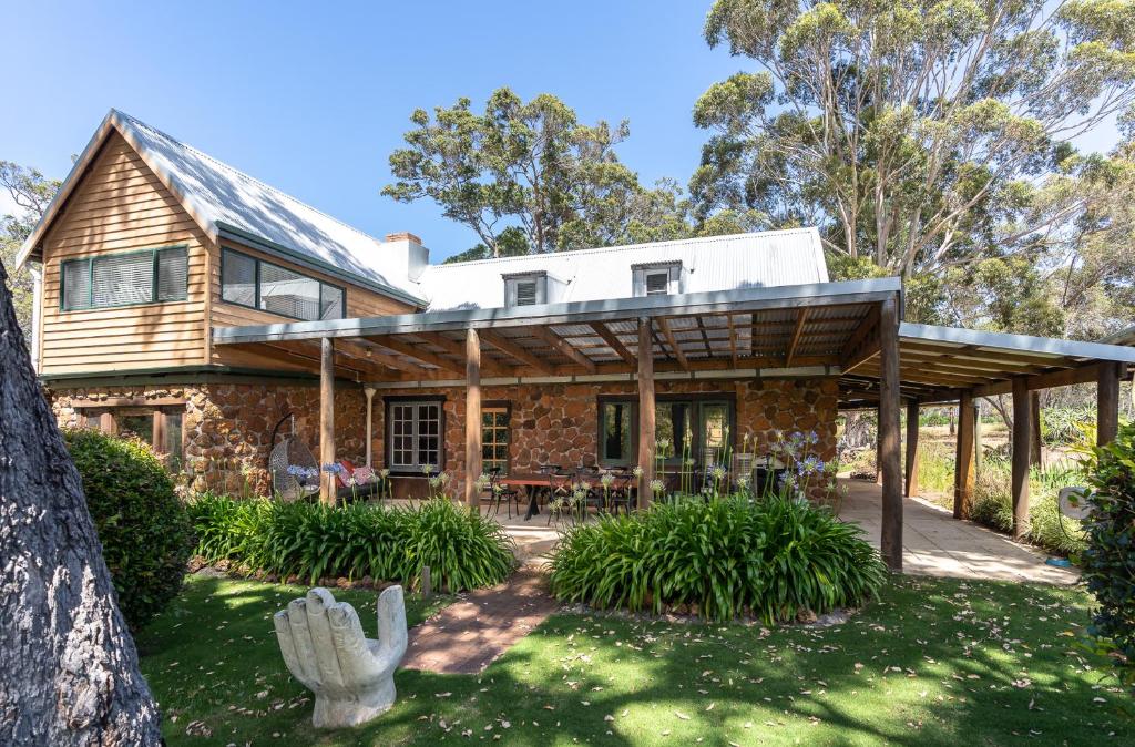 a stone house with a wooden roof at Casa Rua Margaret River in Witchcliffe