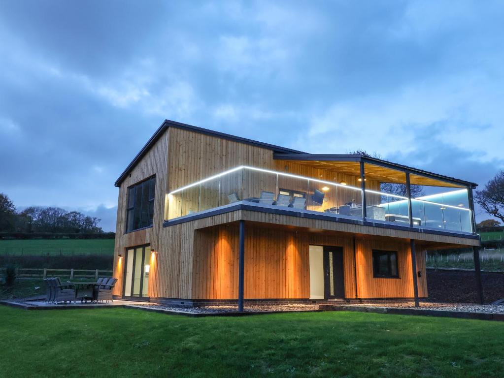 a large house with a large glass facade at Fron Haul - Gwennol in Ruthin