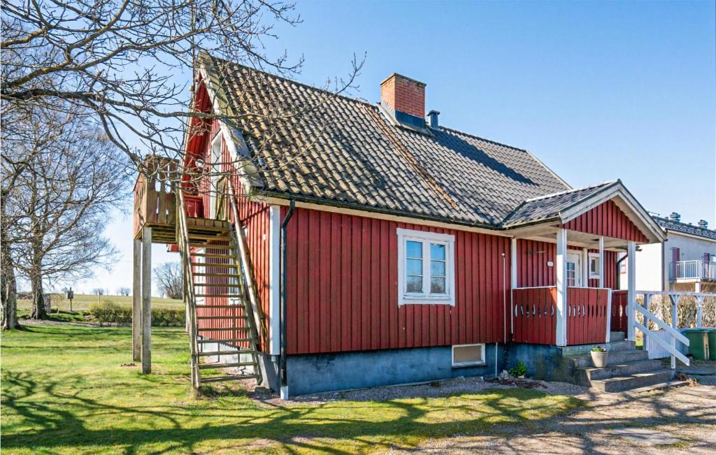 a red house with a staircase leading up to it at Gorgeous Home In Laholm With Heated Swimming Pool in Laholm