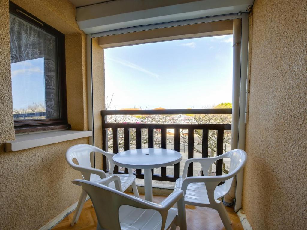 a table and two chairs on a balcony with a window at Appartement T2 - 3 pers - à 400m de la plage, centre station, avec loggia - Biscarrosse Plage - FR-1-521-120 in Biscarrosse-Plage