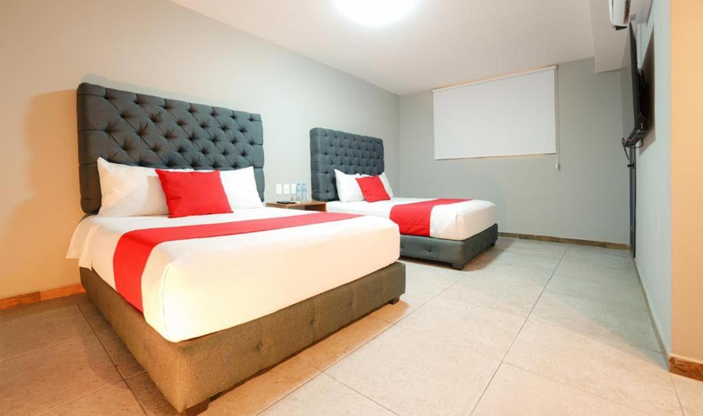 Postel nebo postele na pokoji v ubytování HIT Merida Hotel Boutique