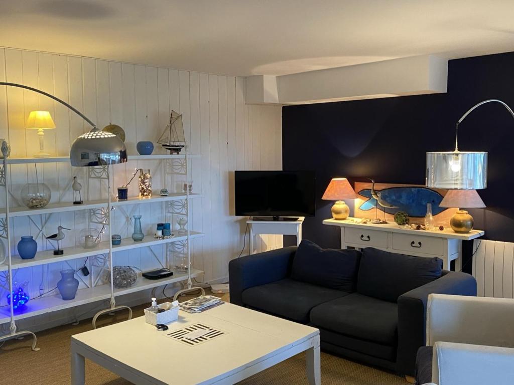 un salon avec un canapé et une table dans l'établissement Grand Duplex en Front de Mer avec 3 Chambres, Animaux Acceptés, Equipements Complets, Cabourg - FR-1-487-321, à Cabourg