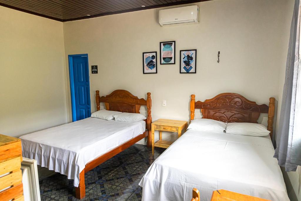 Ένα ή περισσότερα κρεβάτια σε δωμάτιο στο Pousada Aruans Casarão