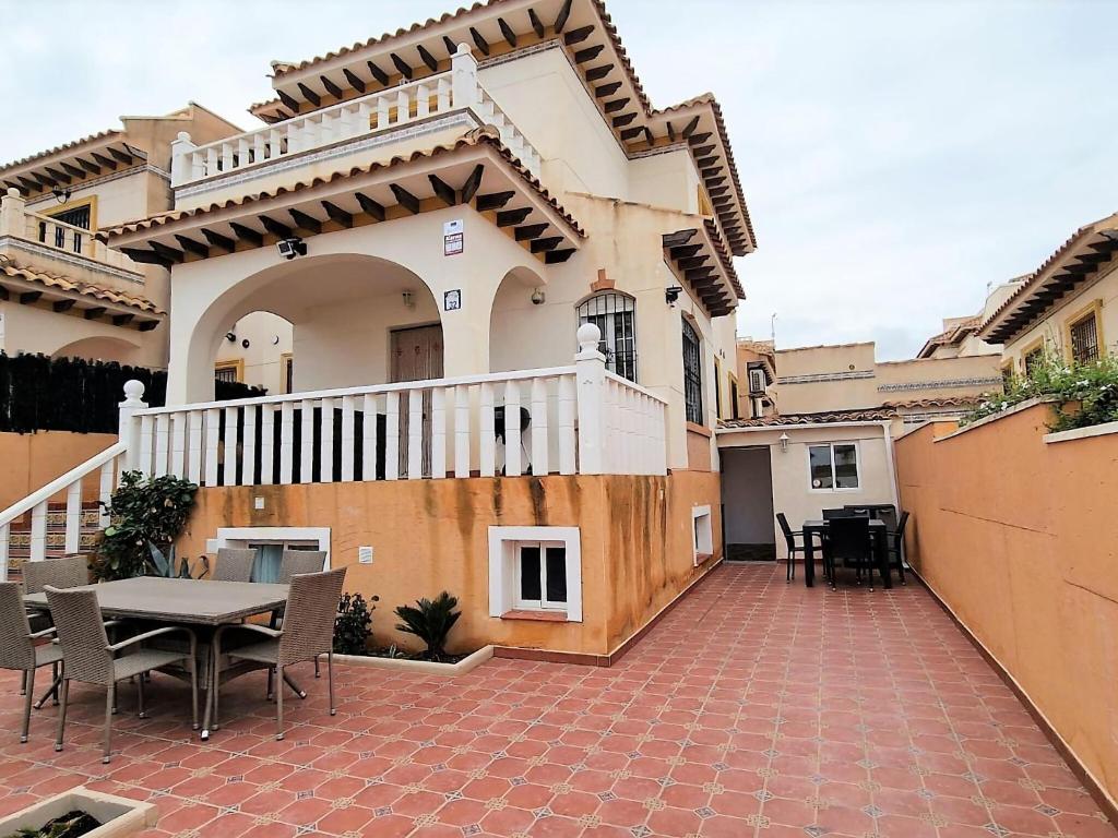 a patio of a house with a table and chairs at Terraced Home in Cabo Roig in Cabo Roig