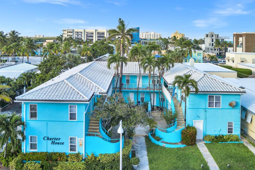 an aerial view of a blue house with palm trees at Charter House in Hollywood