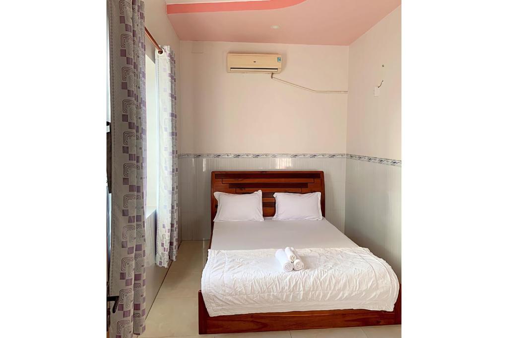 Postel nebo postele na pokoji v ubytování Ngoc May Guesthouse