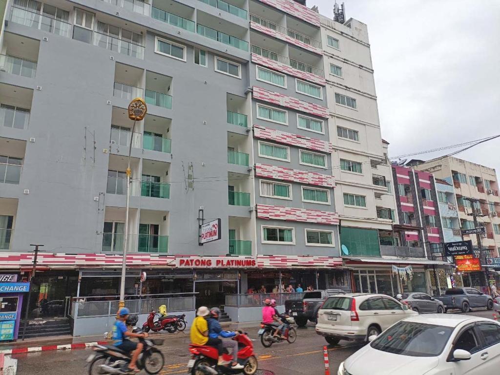a group of people riding motorcycles in front of a building at Patong Platinums Phuket in Patong Beach