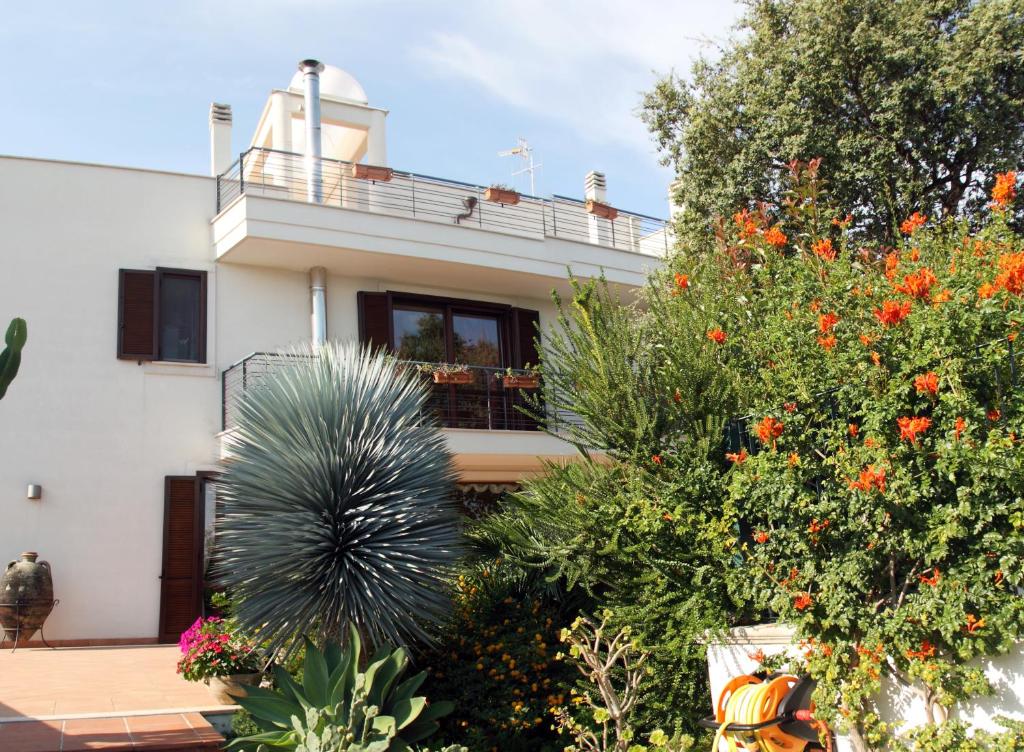 a house with a lot of plants in front of it at B&B Villa il Sughero in Monopoli