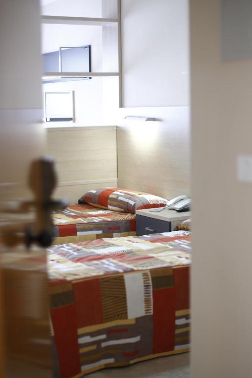 Postel nebo postele na pokoji v ubytování Hotel Rialta