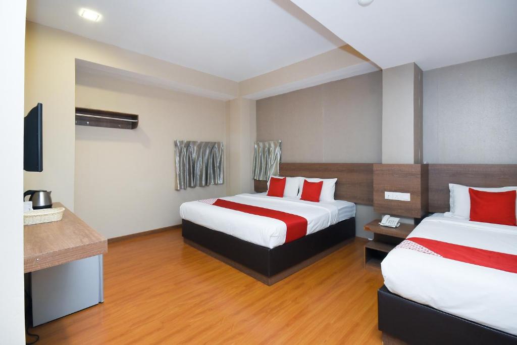 Postel nebo postele na pokoji v ubytování Super OYO 977 Hong Kong Suites