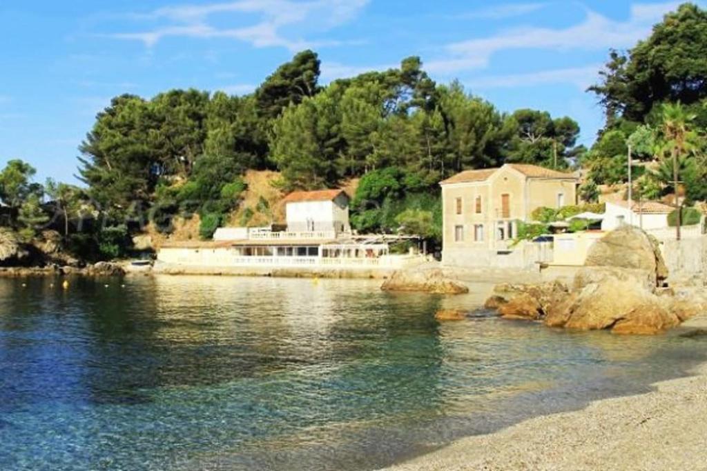 a house on the shore of a body of water at Charming T2 Equipped 1min Walk To Beaches in Toulon